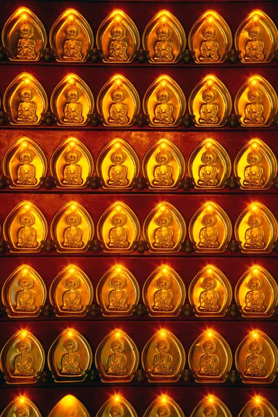 Many small golden Gods shaped coins decorated with pillars in Chinese shrines in Thailand.