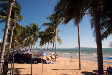 CHONBURI , THAILAND - FEBRUARY 16 , 2020 : Tourists resting on Jomtien Beach Happily on a clear day, the sky is blue on Pattaya ,Chonburi Province ,Middle of Thailand.
