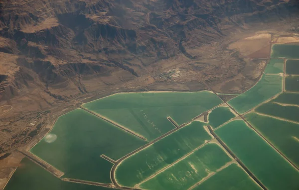 Photo of desert from the plane. View from above.  Situational plan with reservoirs.