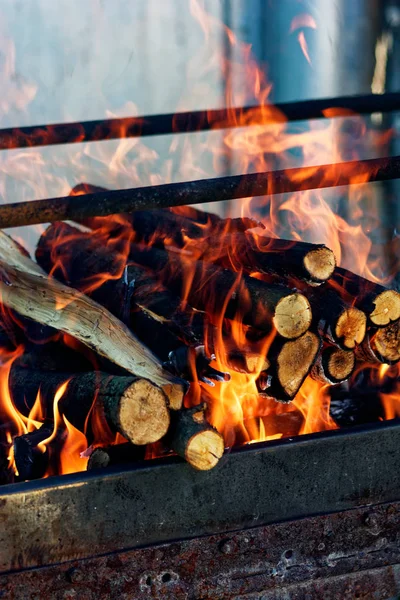 Drewno płonie w kominku. Strona główna Ciepłe ognisko pomarańczowe z kawałkami drewna — Zdjęcie stockowe