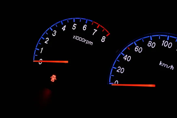 Closeup photo of modern car tachometer on black background, night state — Stock Photo, Image