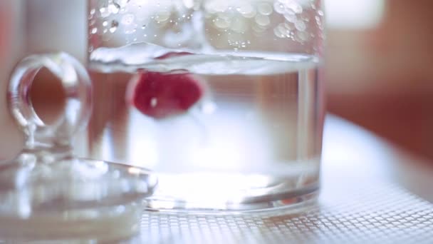 Fresh strawberries is falling down to the water in slow motion — Stock Video