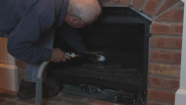 Man Cleaning And Maintaining Home Gas Fireplace Stock Video