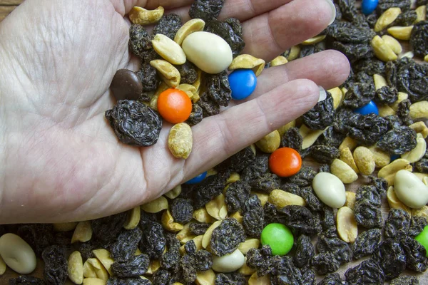 Hand holding trail mix
