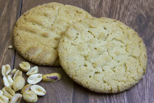 Fresh peanut butter cookies on wooden boards with peanuts