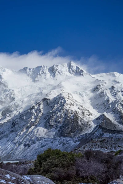 Close up shot of Mount Cook\'s peak cover by snow in winday sunny day.Mount Cook located in Hooker Valler,New Zealand.