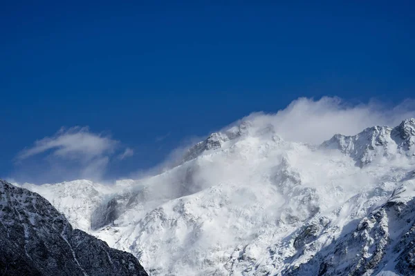Close up shot of Mount Cook\'s peak cover by snow in winday sunny day.Mount Cook located in Hooker Valler,New Zealand.