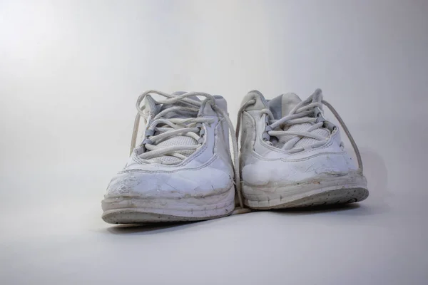 White old running shoes on a white background sense of time passing, consistency etc