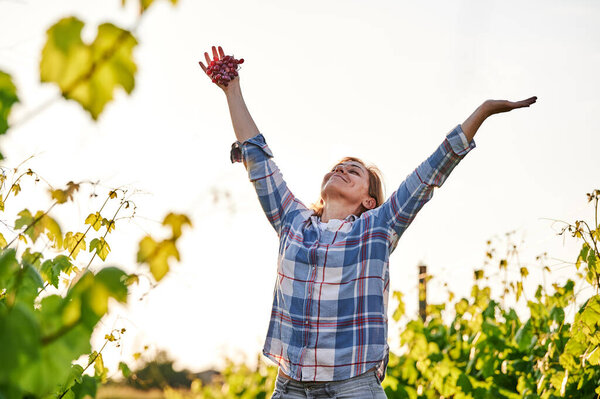 very happy woman walking in a vineyard