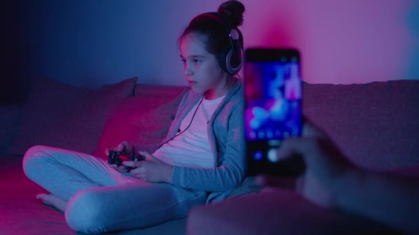 Mãe dispara filha no smartphone que joga eSports em luz de néon — Vídeo de Stock