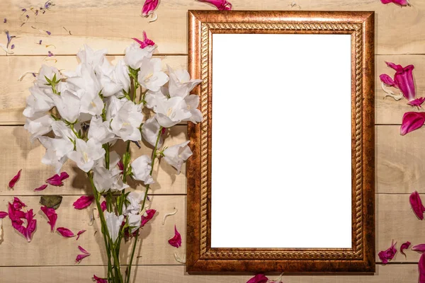 Flowers wooden frame for a picture lie on a wooden table - frame Stock Image