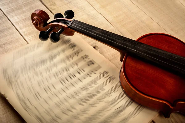 Violin notes on a wooden table — Stock Photo, Image