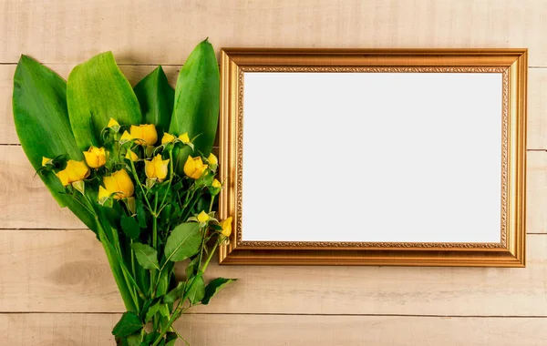 Photo frame and bouquet of yellow dwarf roses Royalty Free Stock Images
