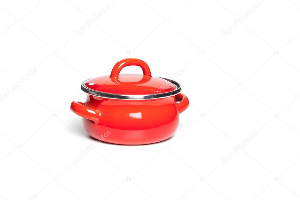 Red cast iron cooking pot, isolated on white background.