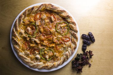 Mantar, domates, peynir, soğan, biber, tuz ve siyah beton zemin üzerinde lezzetli İtalyan pizzası pişirmek için gıda malzemeleri ve baharatlar..