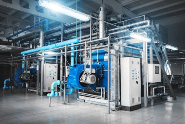 Kazan dairesinin içinde iki gaz kazanı, bir kontrol dolabı ve gaz ve buhar sağlamak için borular var.