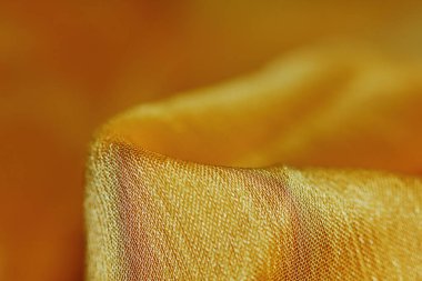 Arka plan için soyut makro kumaşların güzel sarı dokusu