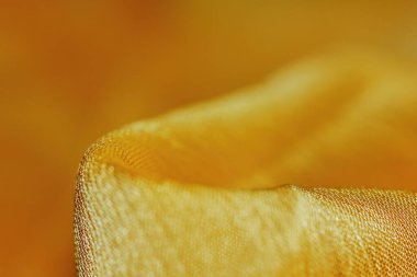 Arka plan için soyut makro kumaşların güzel sarı dokusu