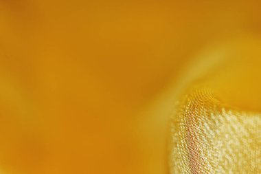 Arka plan için soyut makro kumaşların güzel sarı dokusu