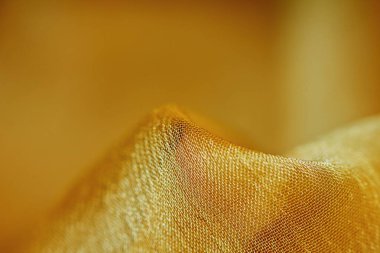 Arka plan için soyut makro kumaşların güzel sarı dokusu
