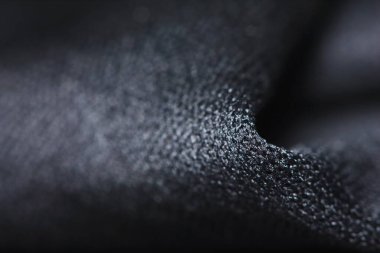 Güzel bir arkaplan için soyut makrodaki kumaşın güzel siyah dokusu