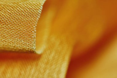 Arka plan için soyut makro kumaşların güzel sarı dokusu