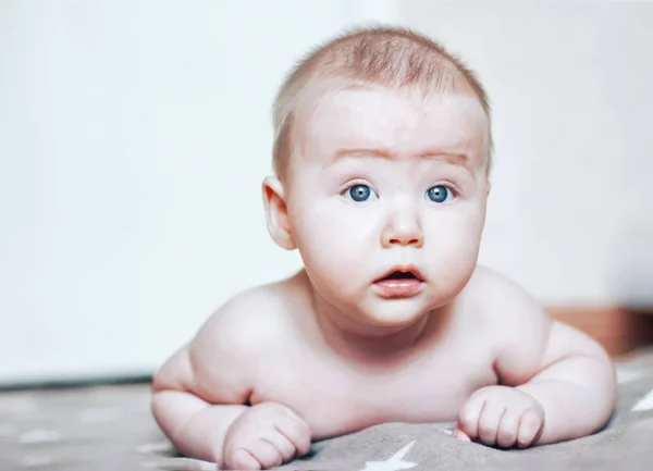 Μικρό αγοράκι βρίσκεται στο στομάχι και το κεφάλι του να ψάχνει λίγο έκπληκτος, νεογέννητο — Φωτογραφία Αρχείου