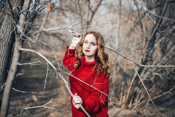 girl in red sweater in forest