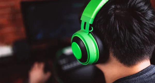 Back view of gamer in headphones playing video game — 스톡 사진