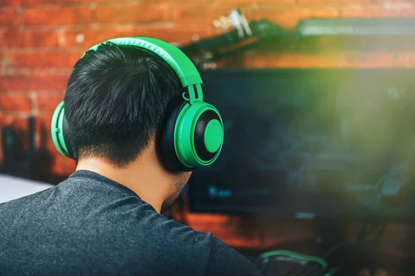Back view of gamer in headphones playing video game — 스톡 사진