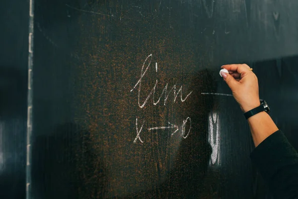 Woman teacher writes formula
