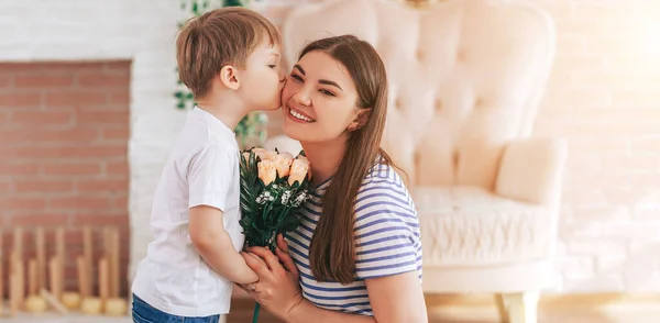 The boy gives beautiful bouquet of flowers to mom — Stock Photo, Image