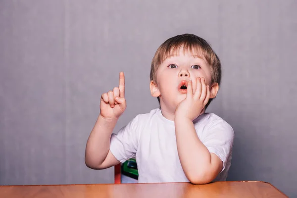 Little Boy Sitting Chair Table Raises His Hand Boy Answers — Stock Photo, Image