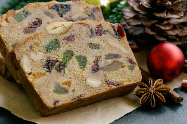 Sweet Fruit Cake Slices Brown Paper Put Black Granite Table — Stock Photo, Image