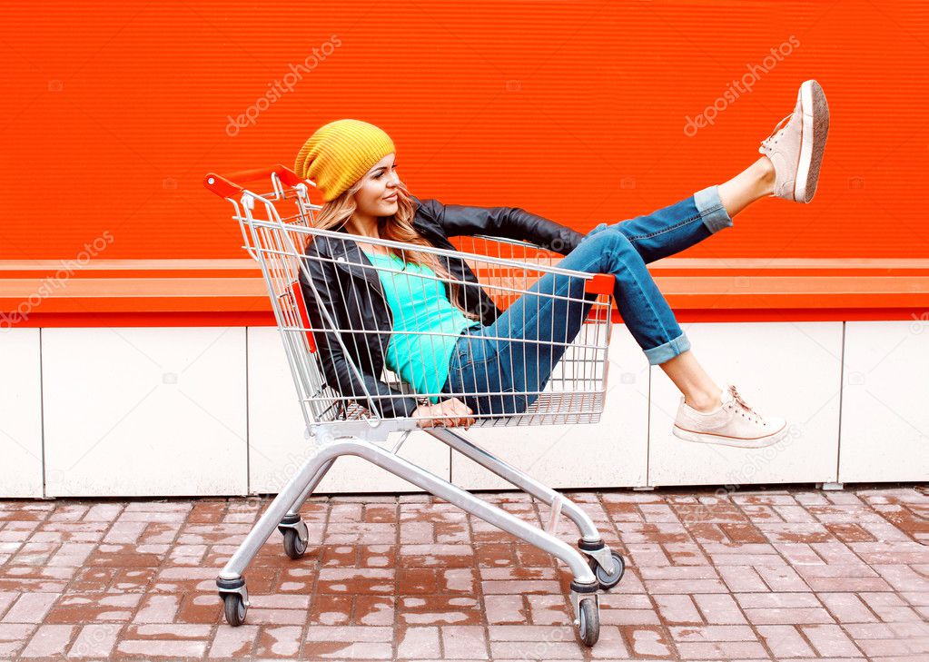 Fashion pretty cool girl in trolley cart wearing black jacket ha