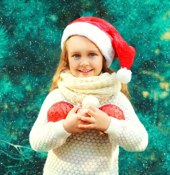 Christmas smiling child little girl in santa red hat with many b — Stock Photo, Image