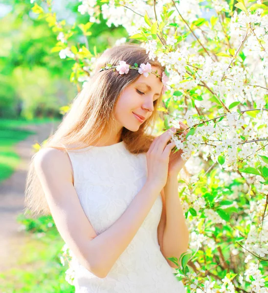 Bella donna godendo fiori primaverili sul giardino — Foto Stock