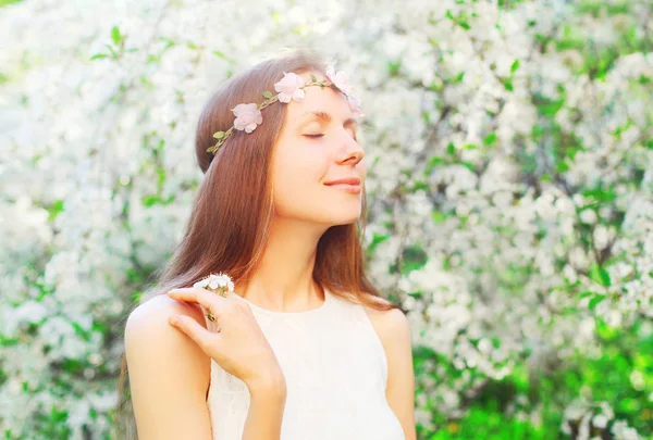 Retrato bonito mulher com floral headband aproveitando cheiro primavera f — Fotografia de Stock