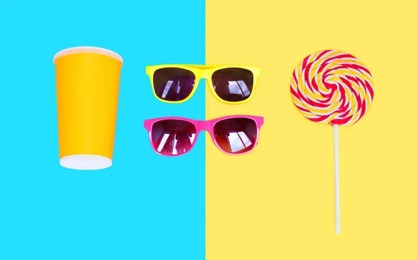 Two sunglasses and colorful lollipop caramel on stick with cup j — Stock Photo, Image