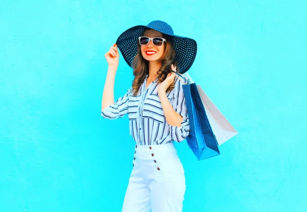Módní mladá usmívající se žena nosí nákupní tašky, slaměný klobouk, — Stock fotografie