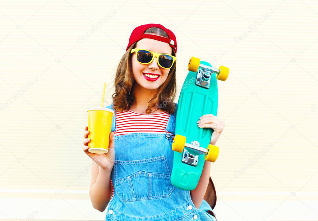 Fashion portrait of happy smiling girl with a cup of juice over 