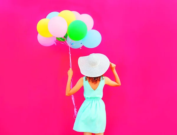 Happy woman holds an air colorful balloons is having fun on a pi — Stock Photo, Image