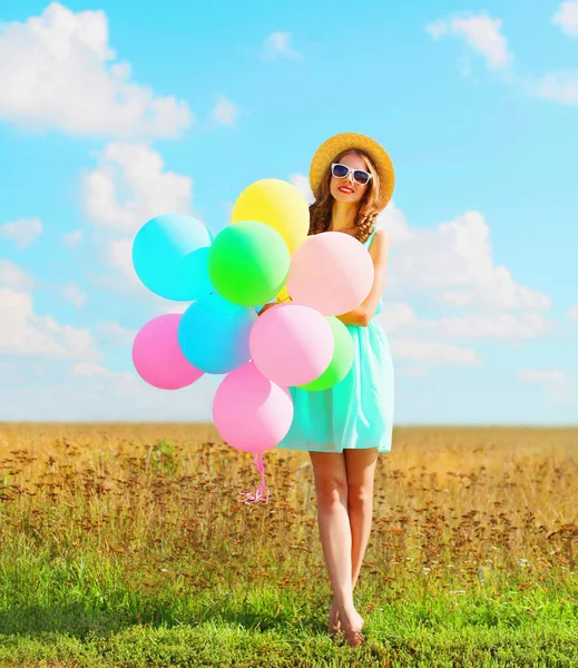 Happy pretty woman with an air colorful balloons enjoying a summ — Stock Photo, Image