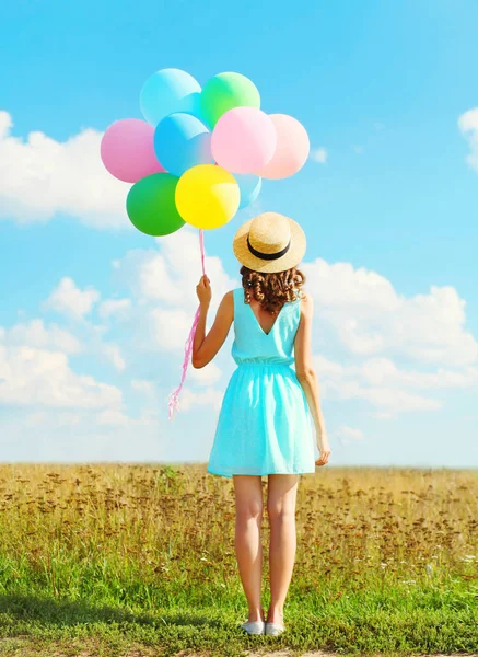 Silhouette happy woman stands with an air colorful balloons in a — Stock Photo, Image