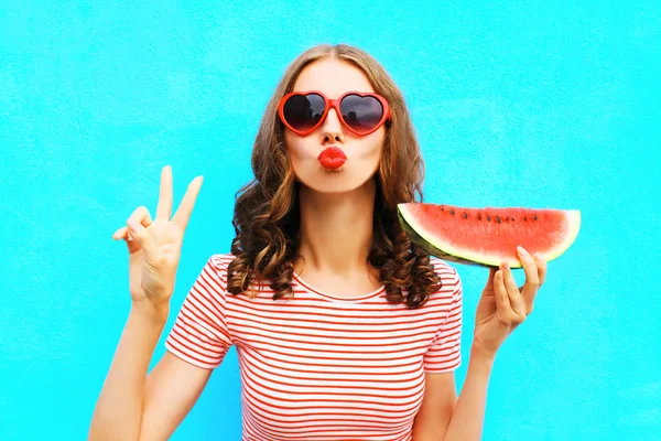 Fashion portrait woman is holding a slice of watermelon and blow — Stock Photo, Image