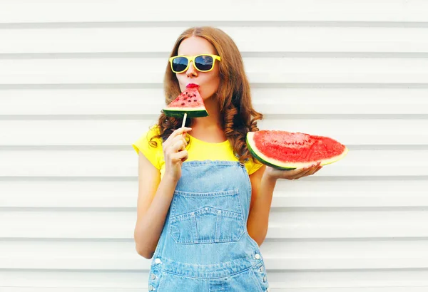 Fashion pretty woman eating a slice of watermelon in the form of — Stock Photo, Image