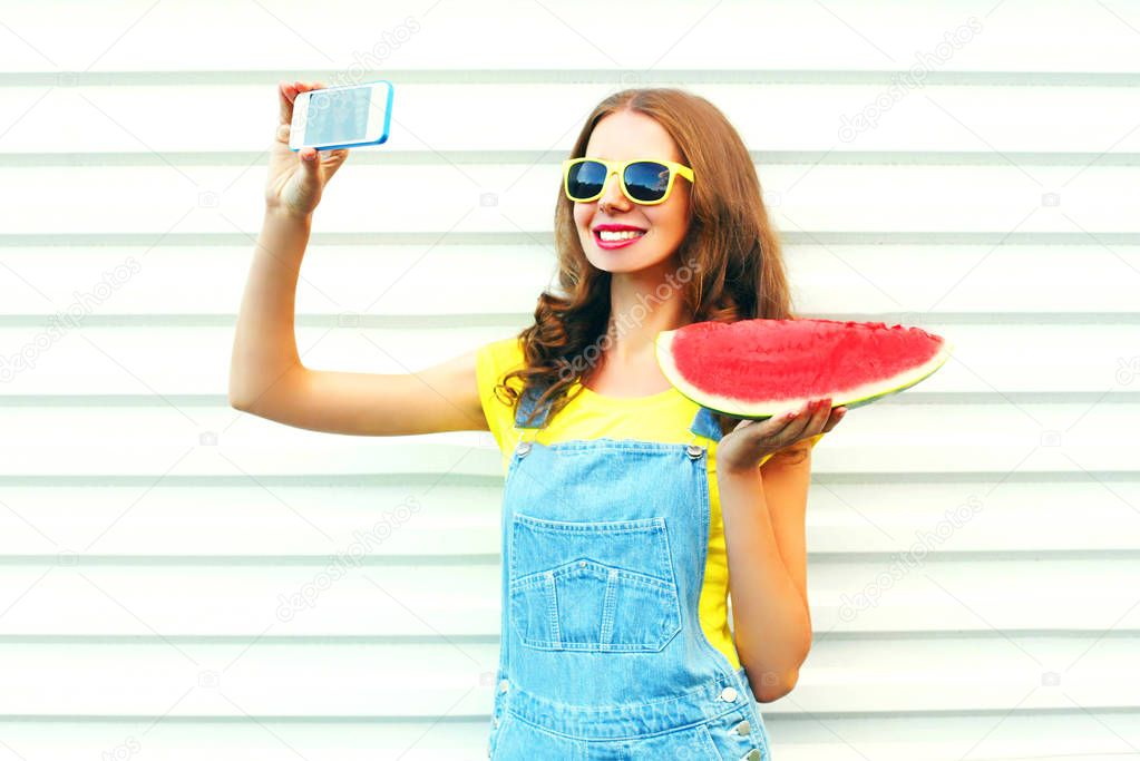 Fashion pretty girl with a watermelon taking picture selfie on t