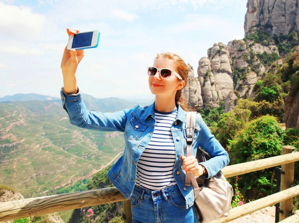 Travel happy smiling woman taking picture selfie on the smartpho