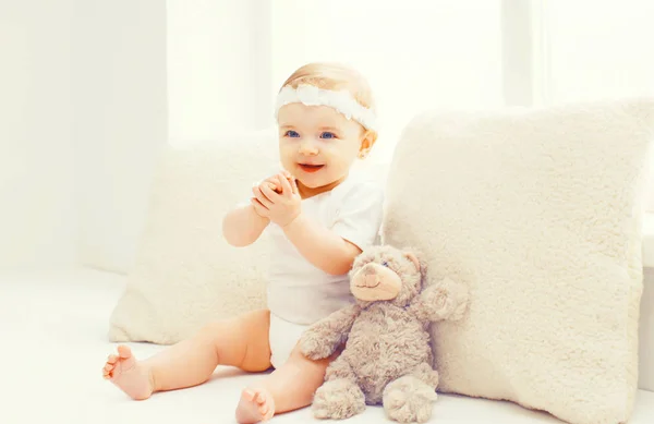 Glücklich lächelndes Baby spielt zu Hause im weißen Zimmer neben dem Fenster — Stockfoto