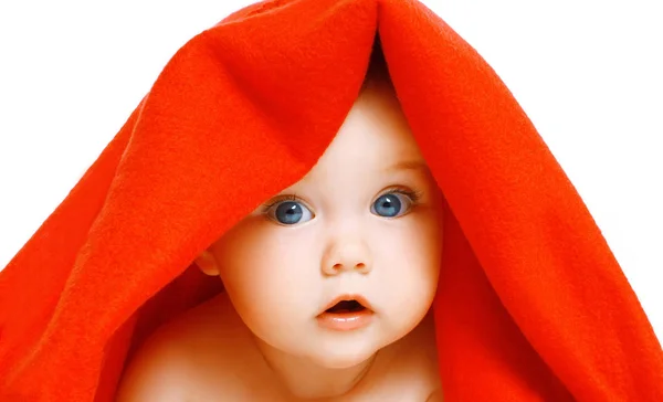 Portrait close-up of face cute baby under red towel on a white b — Stock Photo, Image